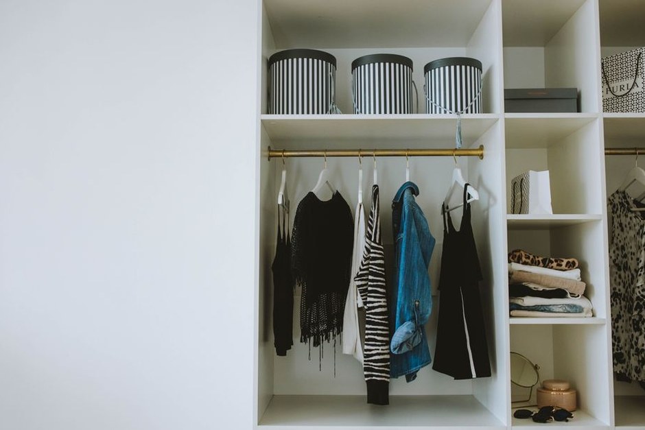 A simple wardrobe and storage area in a bright, organized interior.
