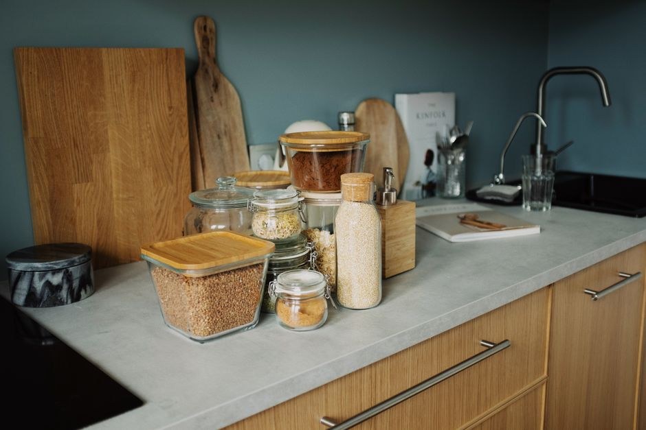 A quiet kitchen shelf with everyday objects arranged in warm natural light.